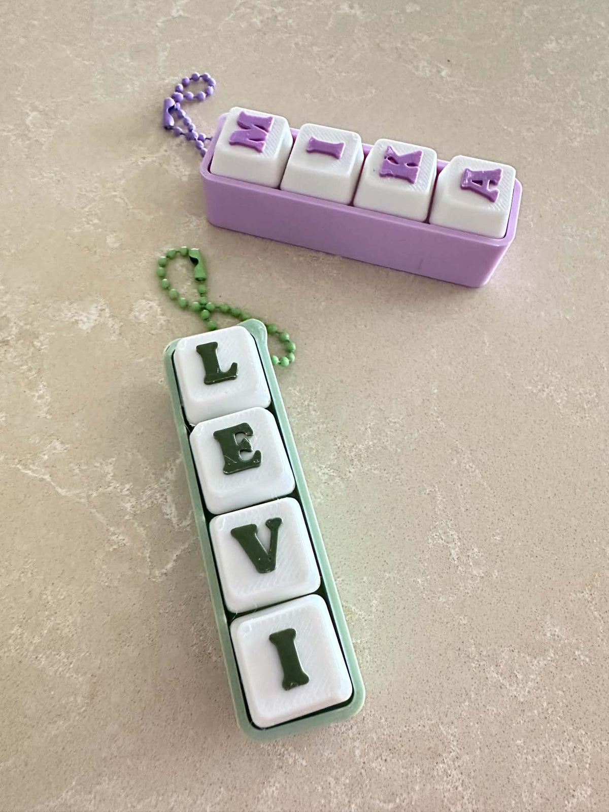 Name Clickers, 3D printed in PLA Matte Pastel Purple, PLA Pro Coconut Milk, PLA Matte Dusty Lilac, PLA Matte Sage Green and PLA Matte Military Green