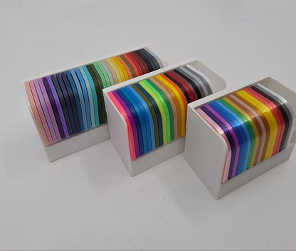 3D printed filament colour sample swatches in organised holders, showcasing a wide range of PLA and PETG colours for 3D printing material selection side angle
