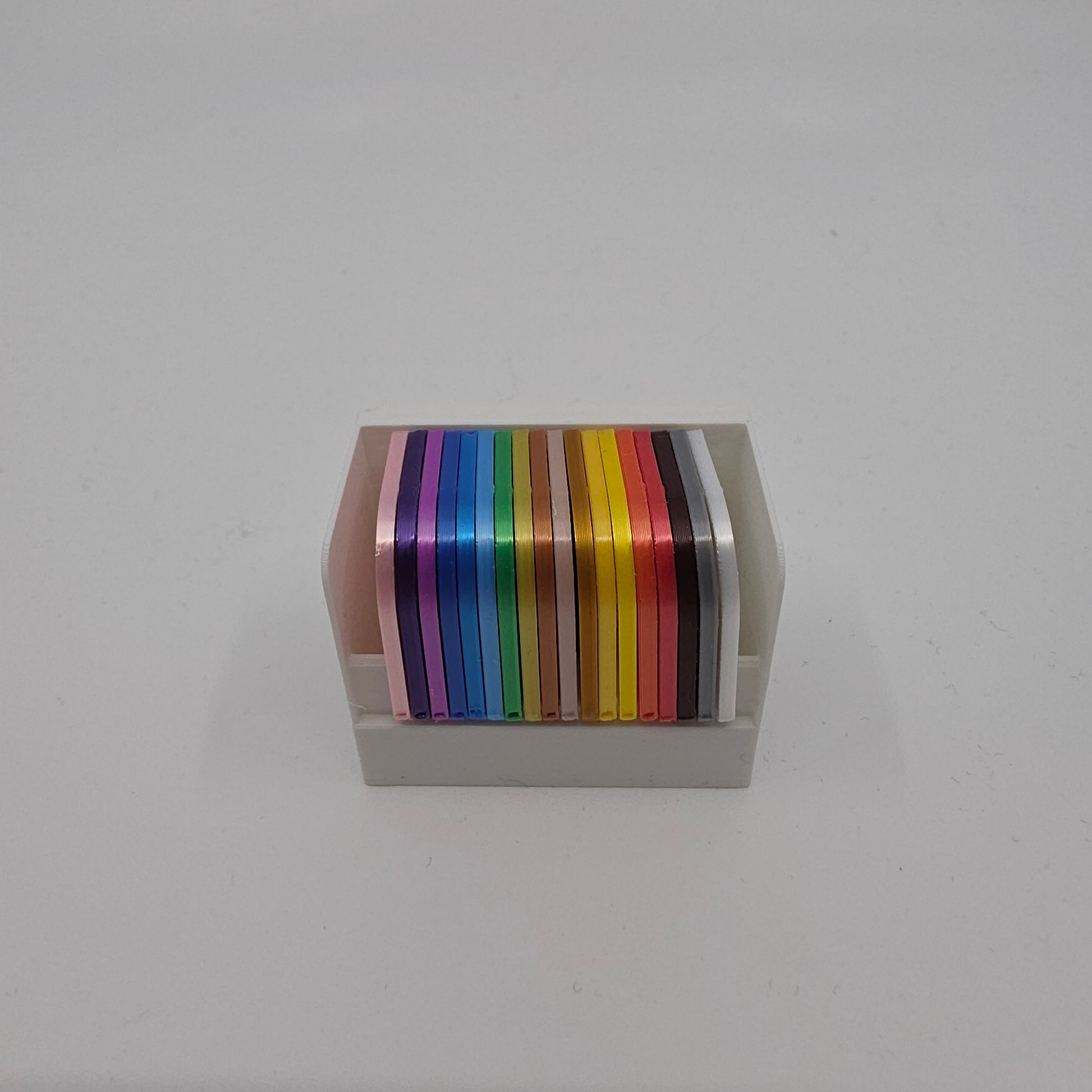 3D printed filament colour sample swatches in organised holders, showcasing a wide range of PLA Silk colours for 3D printing material selection